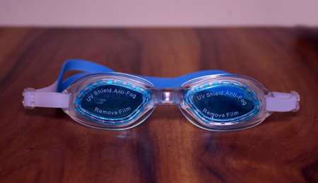 Swimming Goggles kept on a wooden rackの写真素材