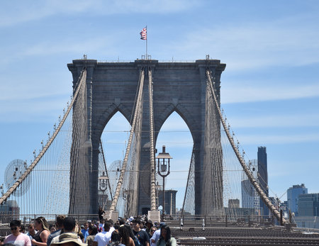 Visitors visiting the beautiful Brooklyn Bridge on a clear day in Newyorkのeditorial素材