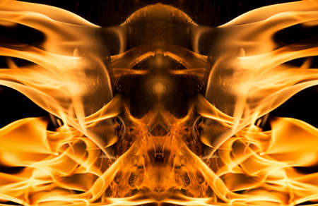 Burning fire in shape of skull on black background.の写真素材