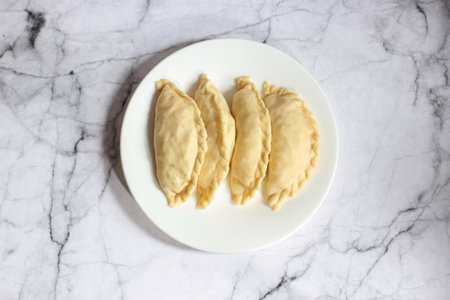 Pastel Goreng is a Popular Pastry in Indonesia. ready-to-cook raw pastel filled with vegetables and chicken meatの写真素材