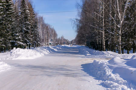 Winter snowy road in the village in russiaの写真素材