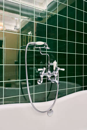 Beautiful cozy luxury bathroom with green tiles