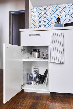 Photo of kitchen cabinet with pots and pansの写真素材