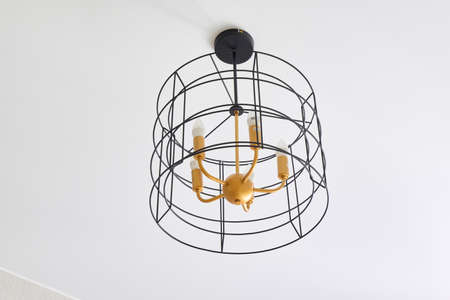 Photograph of a cylindrical chandelier on the ceiling