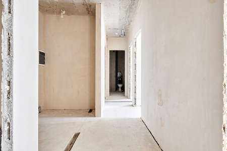 Interior of new apartment without finishing in gray tones