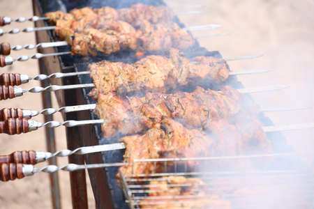 A photo of barbecue on the grill is being prepared