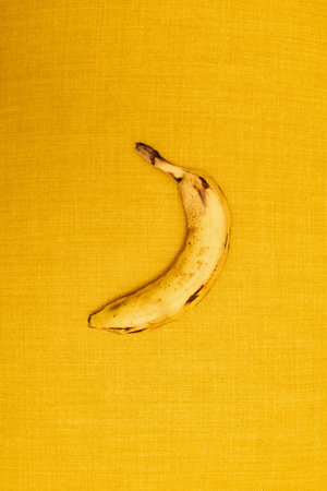Banana with dots on yellow fabric backgroundの写真素材