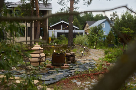 A Serene Garden Pathway That Is Surrounded by Beautiful and Charming Houses Nearbyの写真素材