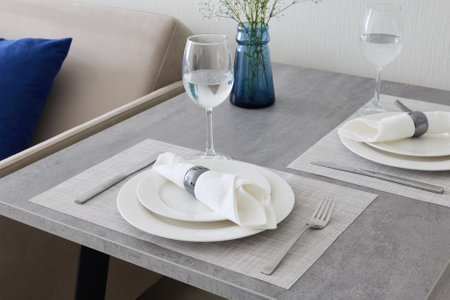 An Elegant Dining Setup Featuring Glassware and Luxurious Cloth Napkins for a Delightful Experienceの写真素材