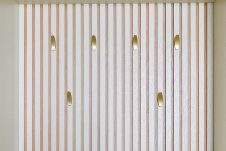 An Elegant Vertical Wall Design Featuring Beautiful Golden Accents Throughout the Space