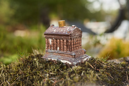 A beautifully crafted Miniature Architectural Model artfully placed on a mossy covered groundの写真素材