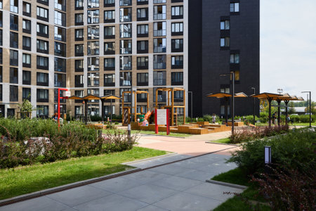 A modern residential complex featuring a vibrant play area and ample green space for relaxation