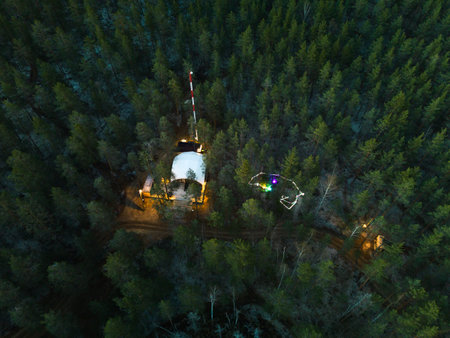 A panoramic aerial view showcasing a remote base that is surrounded by a dense forest area
