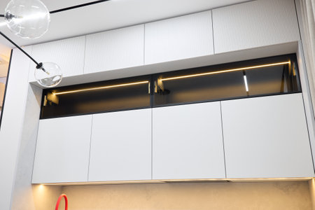 Explore the beauty of Modern Kitchen Cabinets that come with innovative Lighting Featuresの写真素材