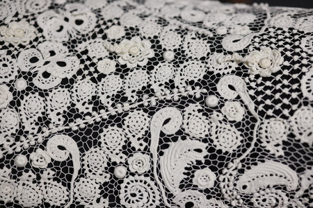 An intricately designed piece showcasing a beautiful white lace with exquisite floral patternsの写真素材