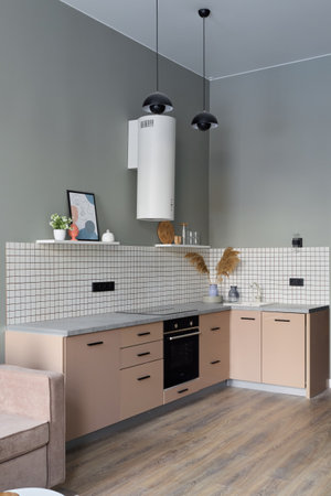 A Modern Minimalist Kitchen Featuring Stylish Decor Accentuated with Warm Color Tonesの写真素材