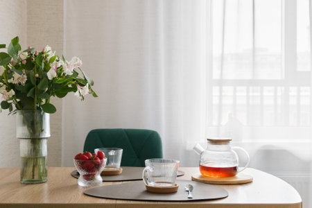 A Cozy Breakfast Setting Featuring Tea and an Array of Fresh, Juicy Berries Ready to be Enjoyedの写真素材