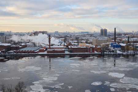 A stunning cityscape with a river and winter reflections, showcasing urban architectureの写真素材