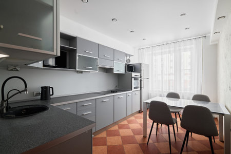 Modern Kitchen Interior Featuring an Elegant Design with Ample Natural Light Inviting You Inの写真素材
