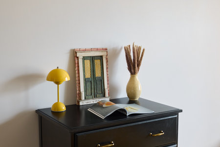 Stylish MidCentury Decor Beautifully Arranged on a Fabulous Black Dresser Surfaceの写真素材