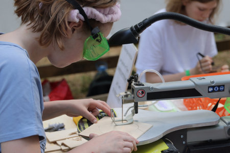 Young Creators Participating Actively in a Sewing Workshop Focused on Engaging Crafting Activitiesの写真素材