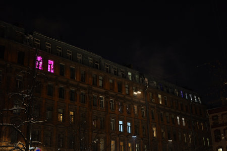 A stunning and captivating night view of a historic building adorned with colorful windowsの写真素材