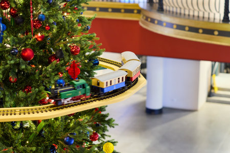 A festive train on a Christmas tree adorned with colorful ornaments spreads joy and cheerの写真素材