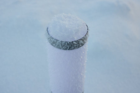 A Majestic SnowCovered Post Standing Proudly in a Beautiful Winter Landscape Sceneの写真素材