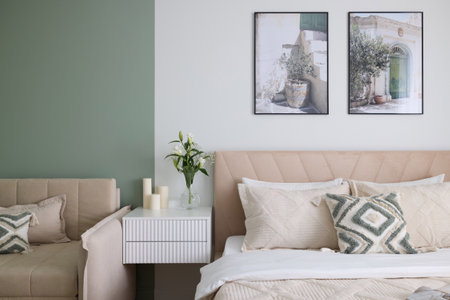 A cozy modern bedroom featuring elegant decor combined with a soothing green accent wallの写真素材