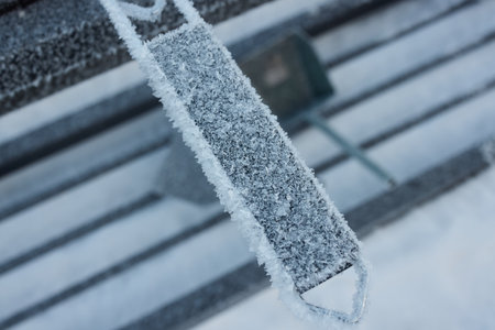 A frosted bench stands out in a winter wonderland, captured in breathtaking artistryの写真素材