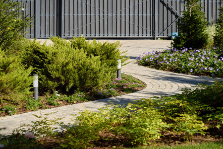 A Beautifully Designed Garden Pathway Surrounded by Lush Flowering Plants and Vibrant Greenery