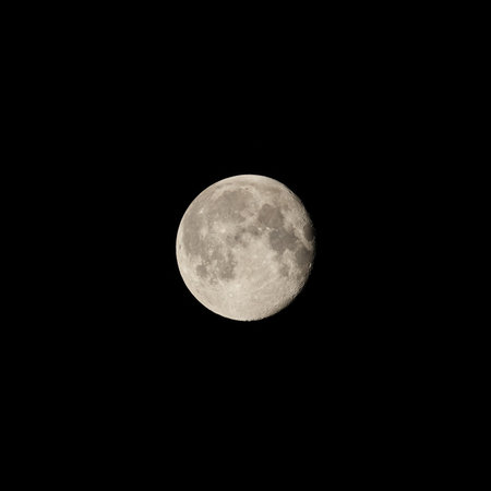 A breathtaking and stunning full moon gracefully illuminates the dark night sky above