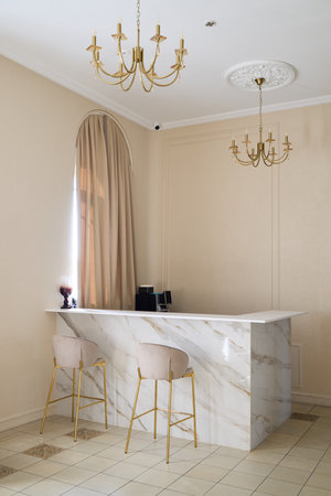 An Elegant Marble Bar Featuring Stylish Decor Set Within a Luxurious Interior Spaceの写真素材