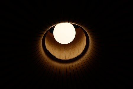 A Beautifully Illuminated Circular Opening Creating a Contrast in an Expansive Dark Spaceの写真素材