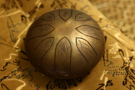 Discover the beauty of a Handcrafted Steel Tongue Drum with an Intricate Design that inspires