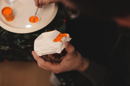 Engaging in Creative Crafting Projects using Orange Paint to Express Artistic Freedom and Styleの写真素材