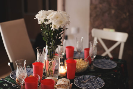 An Elegant Dinner Table Setting Featuring Beautiful Flowers and Festive Decorative Elements