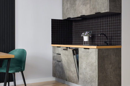 Explore Modern Minimalist Kitchen Design with Concrete and Black Tile accents for styleの写真素材