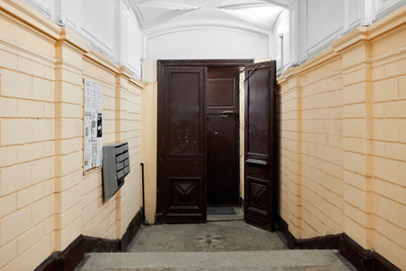 Charming Vintage Apartment Entryway Featuring Double Doors with Classic Detailed Decor