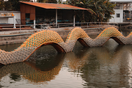 The Serpentine Bridge Over the Tranquil Waters is Showcased in Beautiful Vibrant Colorsの写真素材