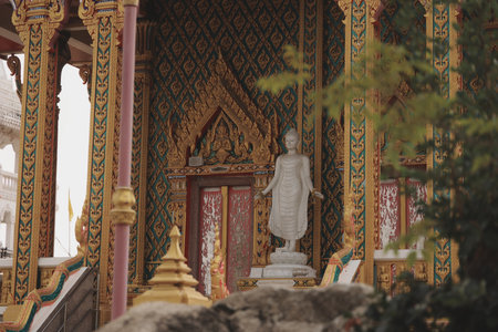 A beautiful Buddha statue in an ornate temple radiates tranquility, inviting reflection