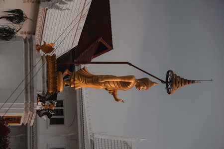 The Golden Buddha Statue Standing Gracefully Under a Beautiful Sky Above