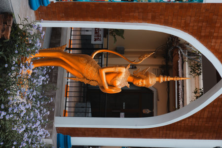 A Captivating Golden Statue of a Mythical Figure Set in a Beautiful and Serene Environment