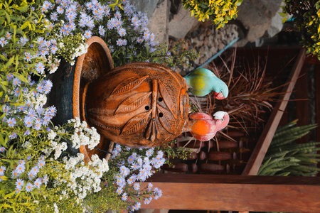 A Beautiful and Colorful Arrangement of Parrots on a Decorative Pot Surrounded by Vibrant Flowers
