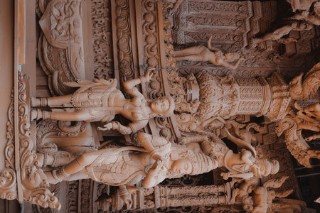 The Intricate Carvings Found on the Temple Wall Illustrate Various Divine Figures and Symbolismの写真素材