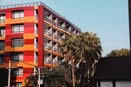 A Vibrant and Modern Apartment Building Surrounded by Beautiful Palm Trees and Landscapes