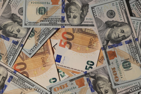 A visually captivating array of diverse currency notes featuring a mixed background of USD and Euro