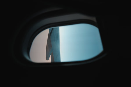 The incredible view from an airplane window showcases the wing and the vast sky beyond