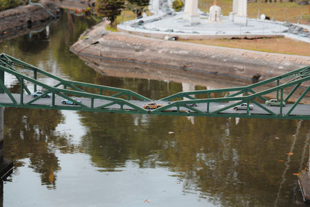 A beautiful and scenic view of a suspension bridge gracefully spanning over calm watersの写真素材