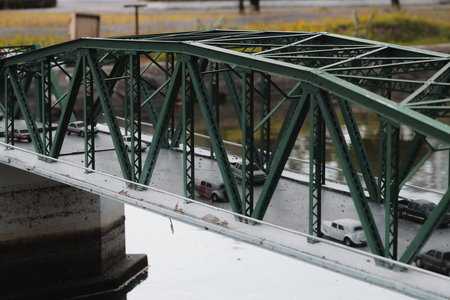 An InDepth Perspective of a Beautiful Green Truss Bridge Accommodating Traffic Flowの写真素材